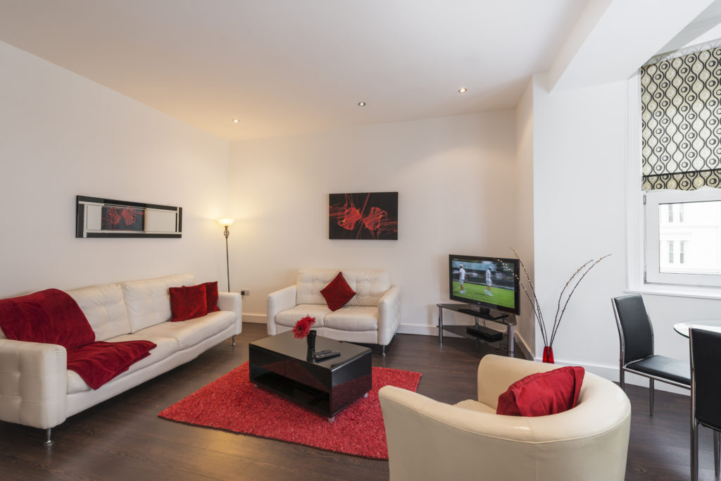 room with sofa and TV in red
