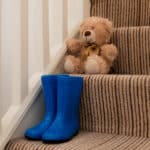 welly boots and teddy on the stairs at Strathmore House Apartments